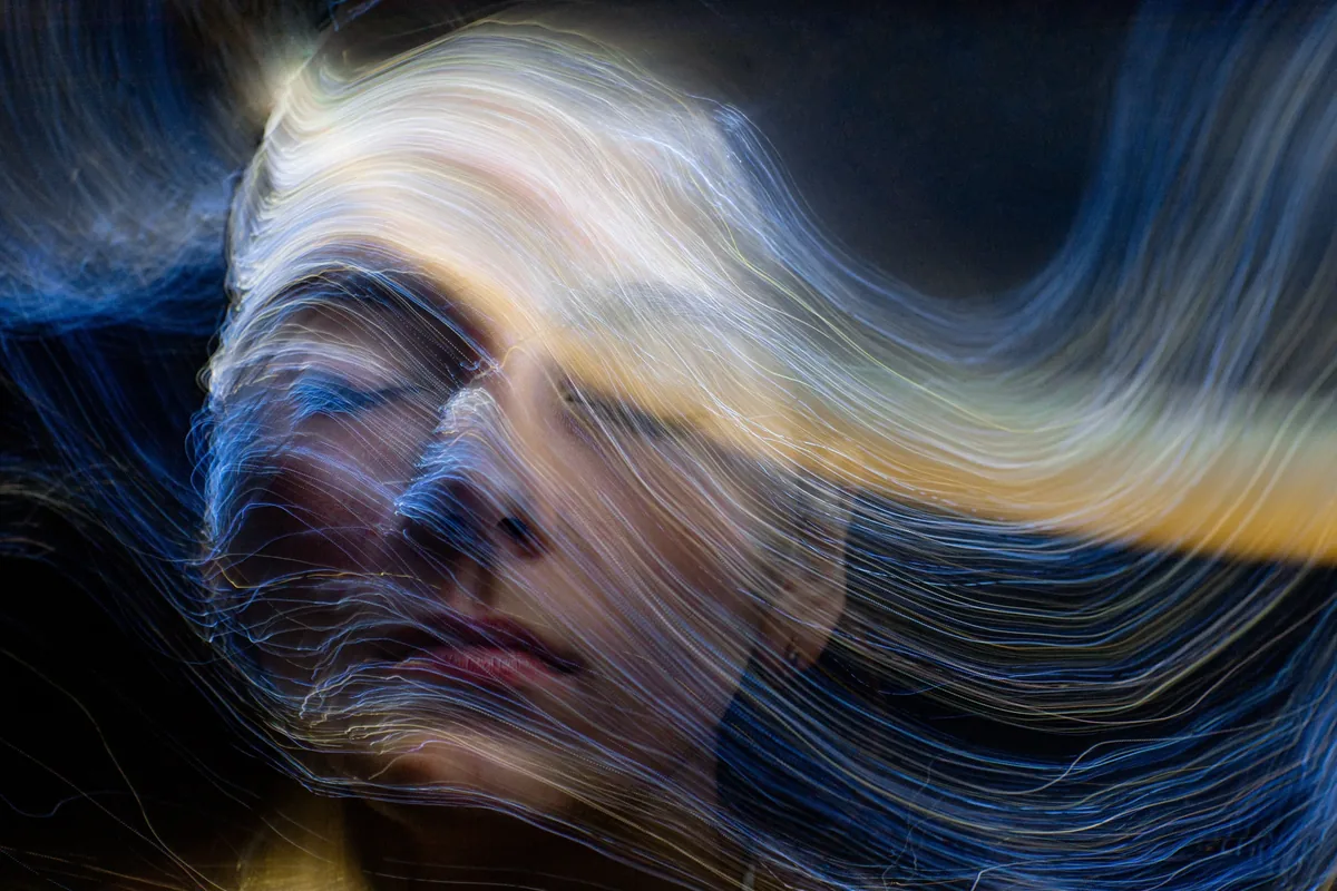 Luz expandiéndose sobre un fondo oscuro, imagen de la consciencia